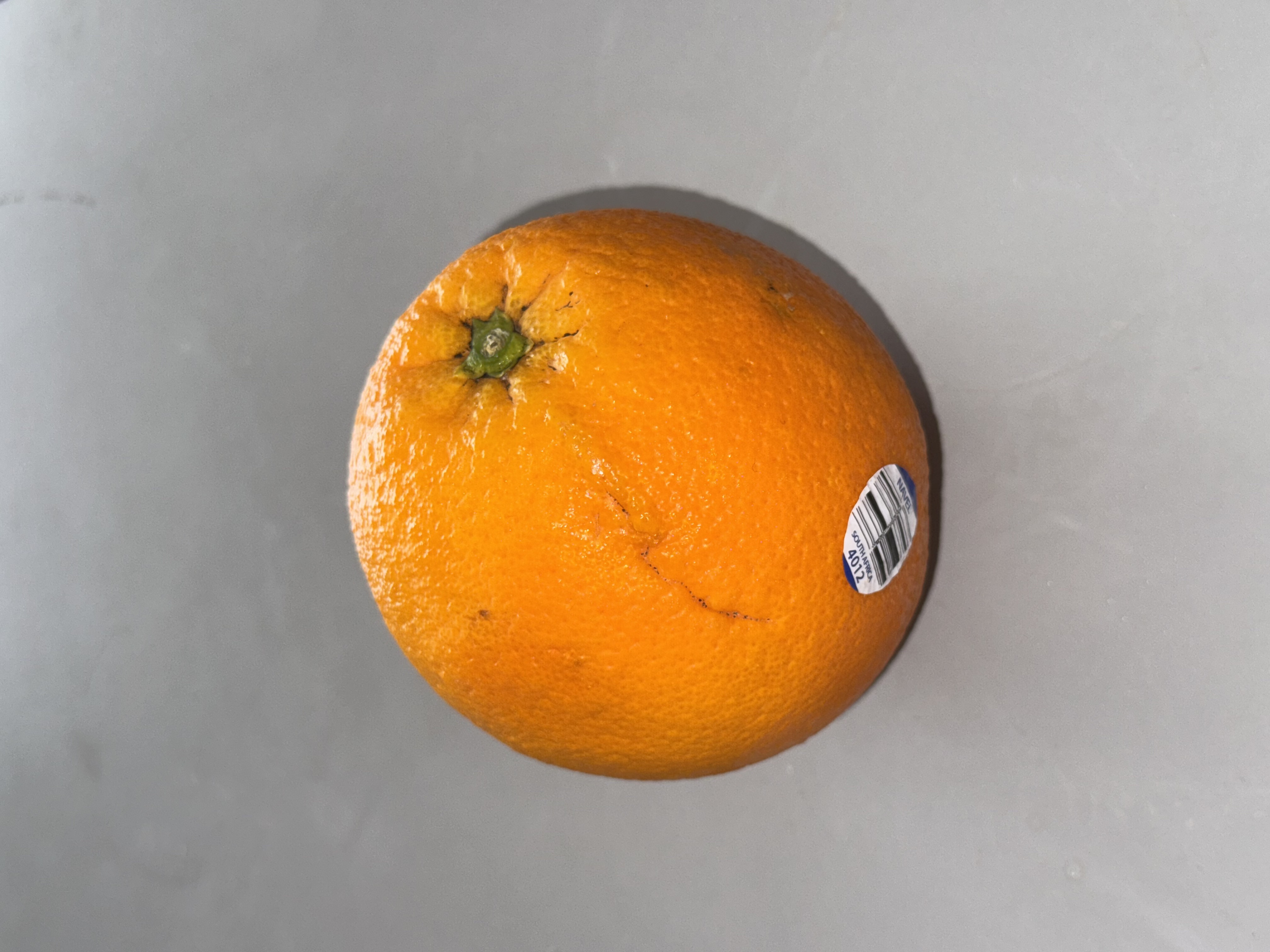 This is a high-angle and slightly side shot image of an orange.